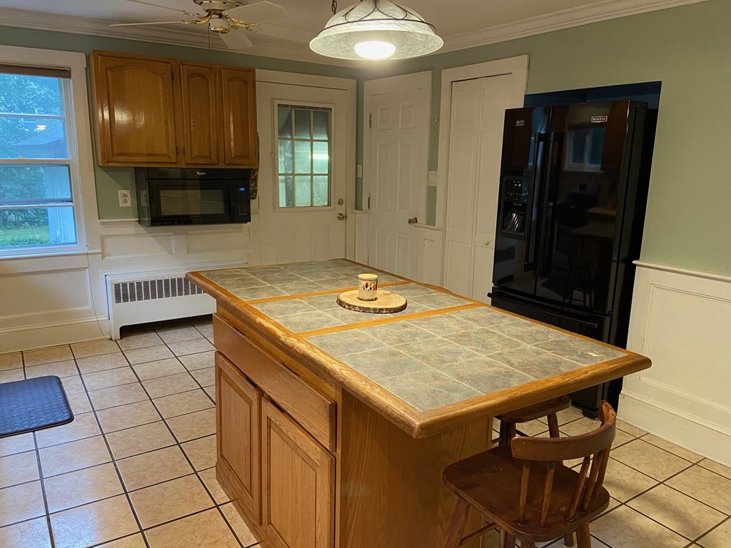 16 Worcester Road Townsend, MA 01469 - Photo 5 of 31 a kitchen with a table chairs and refrigerator