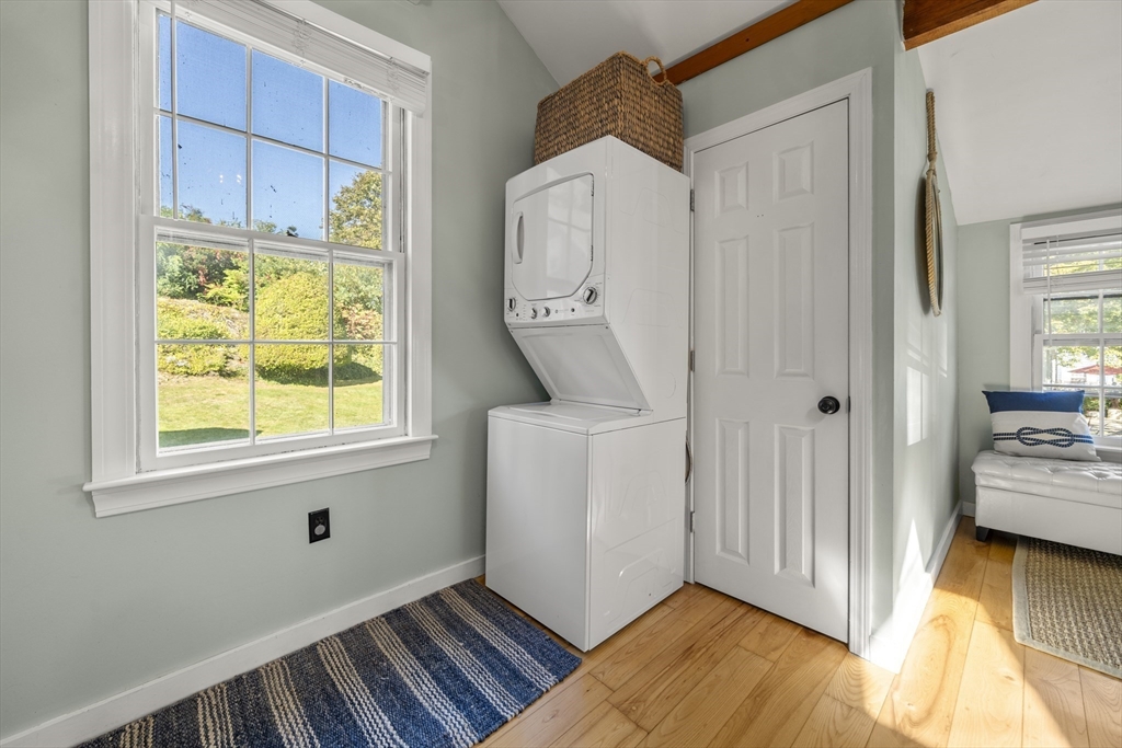 9 Gingerbread Hill, Unit 1 Marblehead, MA 01945 - Photo 12 of 16 a view of an entryway with wooden floor and a bedroom