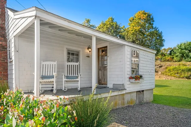 a view of a house with a yard and sitting area
