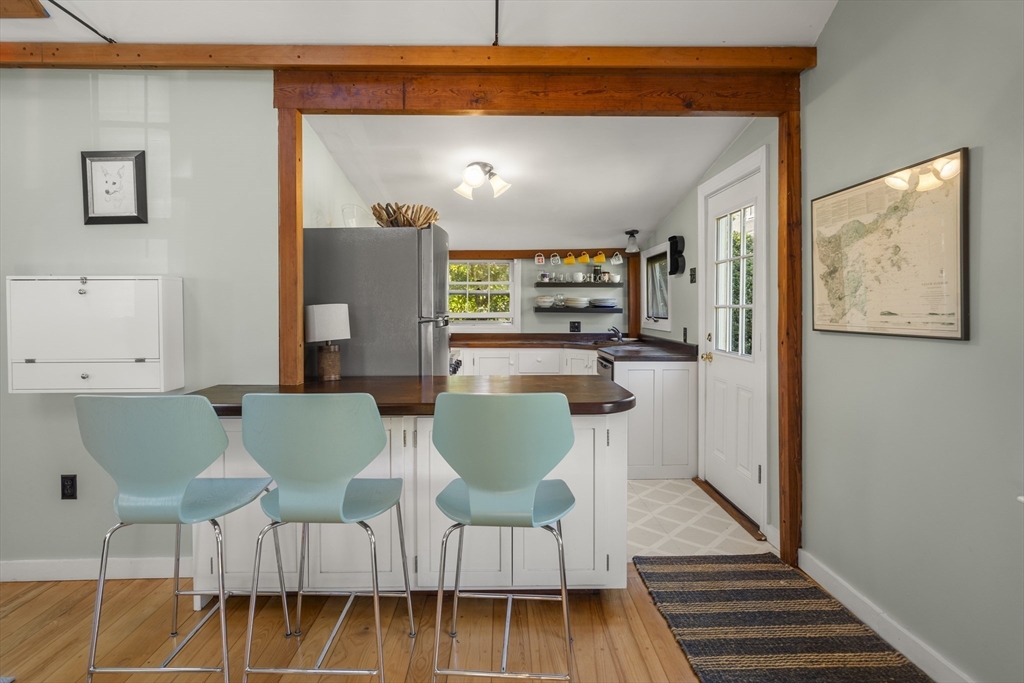 9 Gingerbread Hill, Unit 1 Marblehead, MA 01945 - Photo 8 of 16 a living room with furniture and a wooden floor