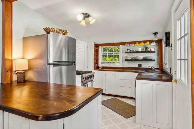 a kitchen with stainless steel appliances granite countertop a sink a stove and refrigerator