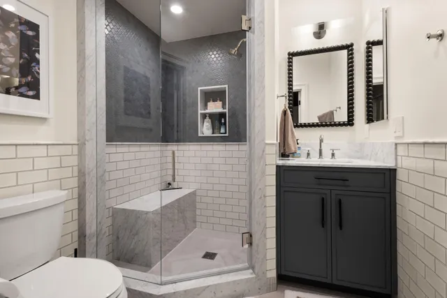 a bathroom with a sink a toilet and shower