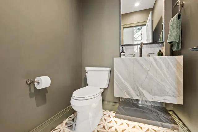 a bathroom with a toilet and a sink