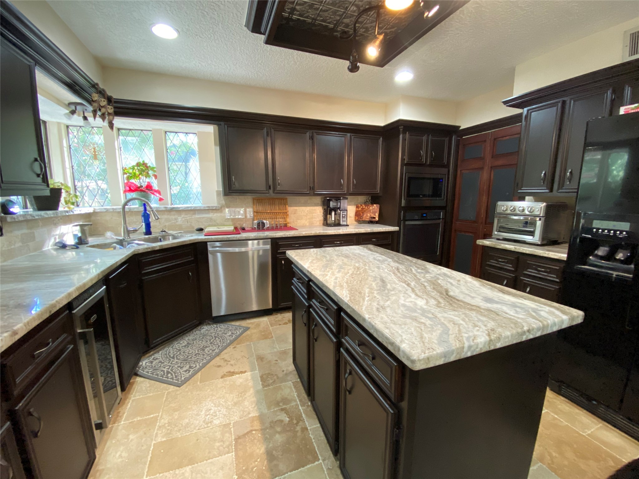 28 Tangle Brush Drive Spring, TX 77381 - Photo 13 of 29 a kitchen with stainless steel appliances granite countertop a sink counter space cabinets and a counter top space