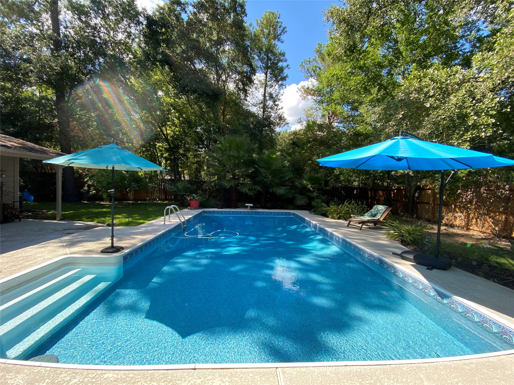 28 Tangle Brush Drive Spring, TX 77381 - Photo 2 of 29 a view of pool with table and chairs under an umbrella