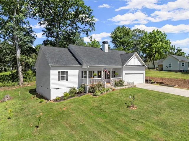 a front view of house with yard and green space