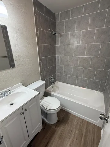 a bathroom with a sink a toilet and bathtub