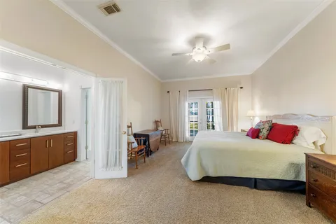 a bedroom with bed and a table with rug