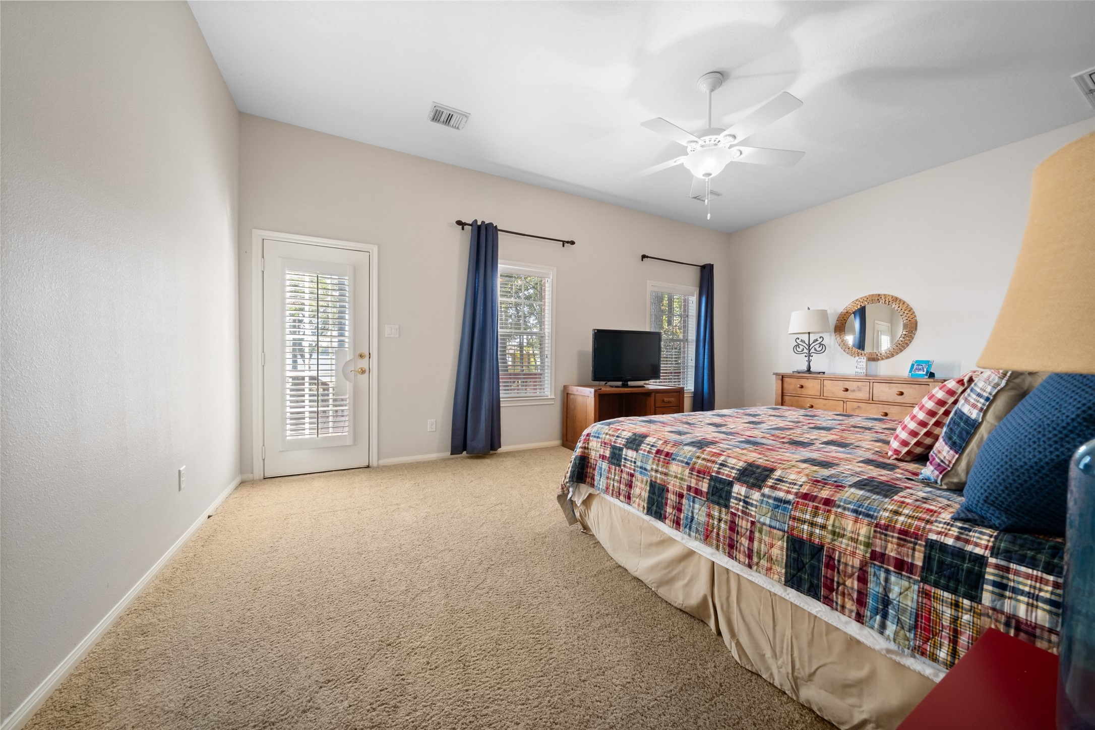 15144 Paradise View Drive Willis, TX 77318 - Photo 27 of 44 a spacious bedroom with a large bed and a chandelier