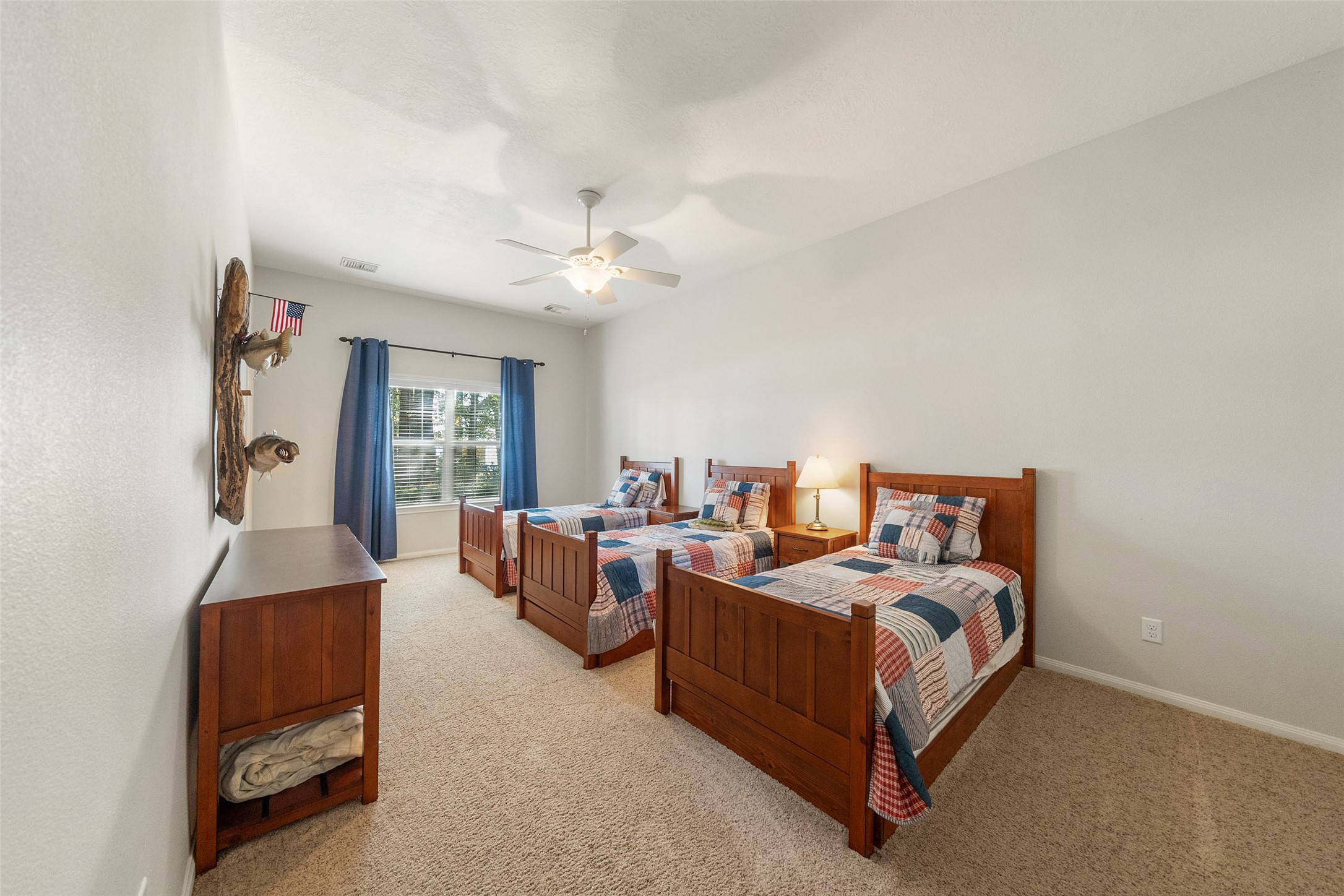 15144 Paradise View Drive Willis, TX 77318 - Photo 29 of 44 a spacious bedroom with a bed and a chandelier