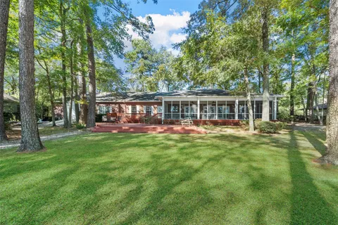 a living room with furniture tv and a large window