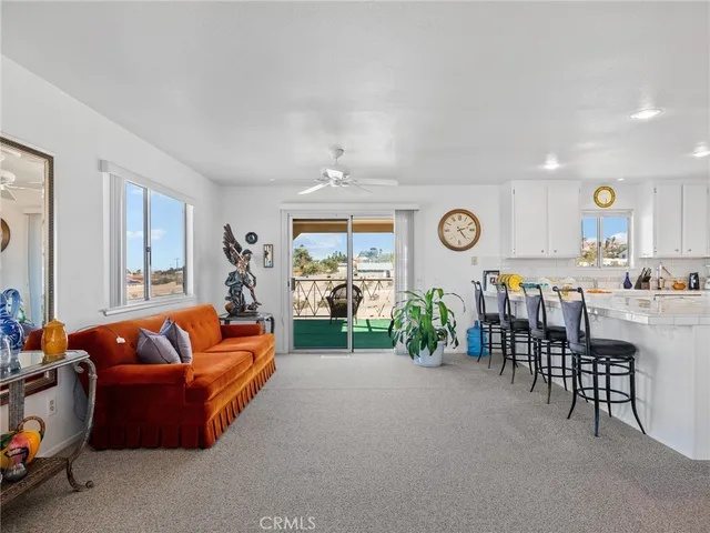a living room with furniture and ceiling fan