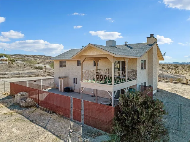 a front view of a house with balcony and garden