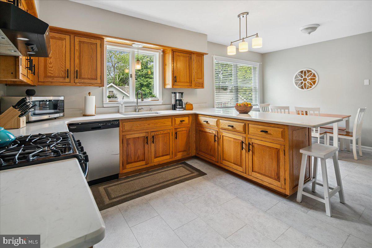 8 High Acres Drive Ewing, NJ 08628 - Photo 11 of 43 a kitchen with a sink stove and wooden cabinets