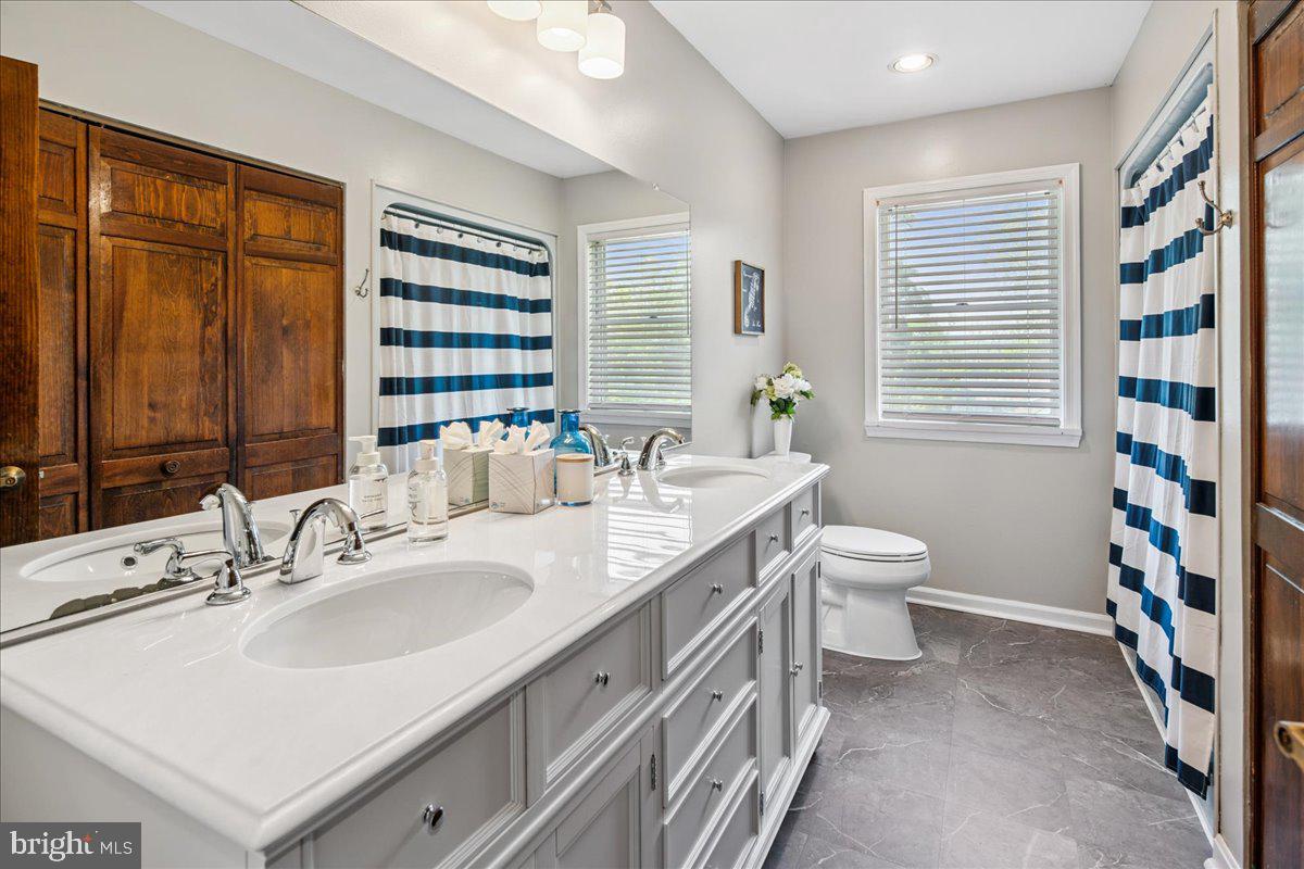 8 High Acres Drive Ewing, NJ 08628 - Photo 21 of 43 a bathroom with a double vanity sink toilet and shower