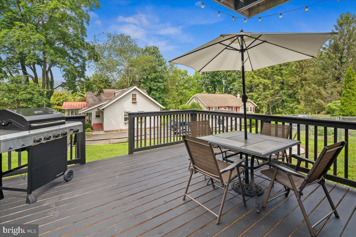 8 High Acres Drive Ewing, NJ 08628 - Photo 43 of 43 a view of a roof deck with table and chairs under an umbrella