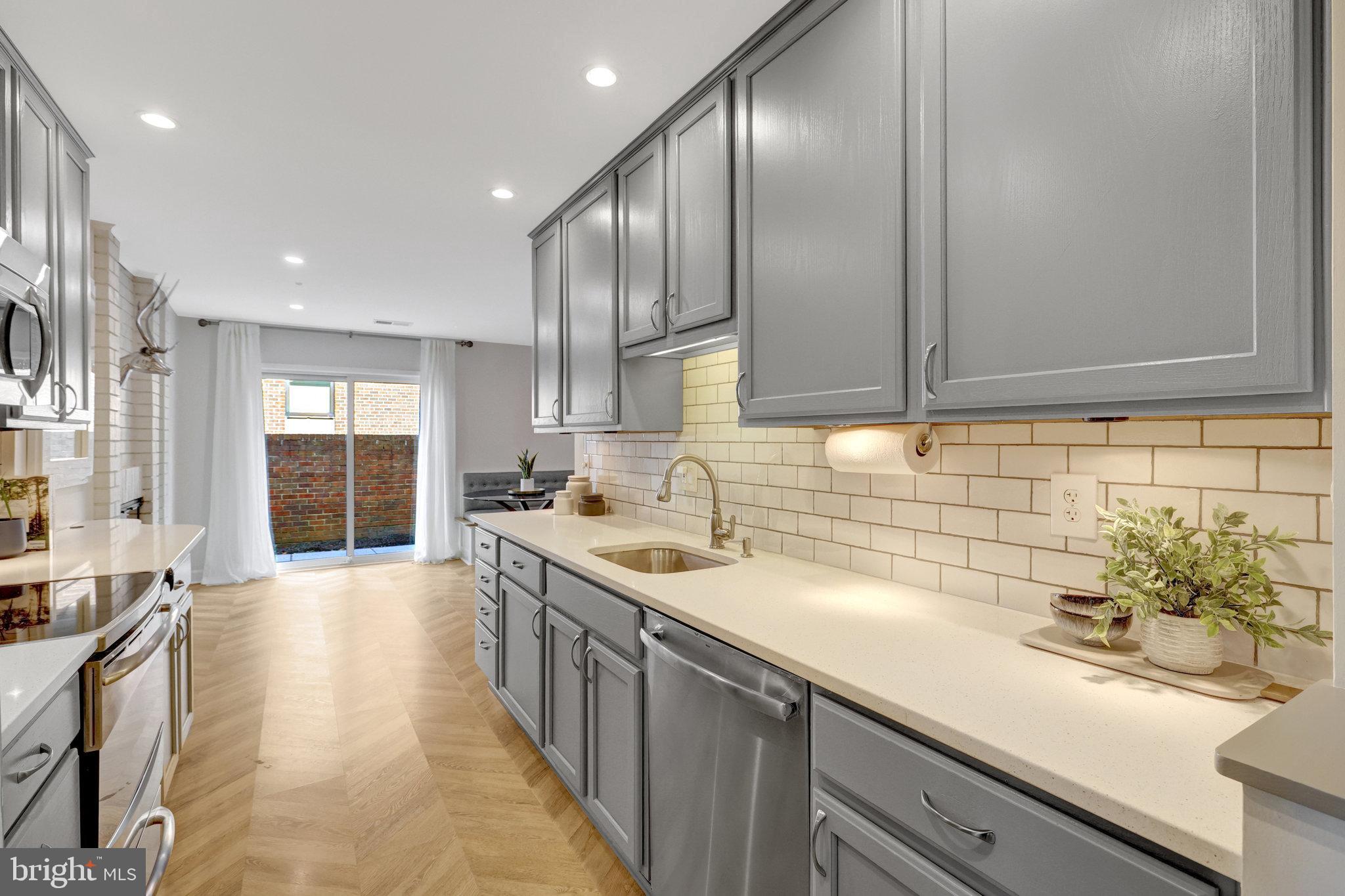 11712 Indian Ridge Road Reston, VA 20191 - Photo 14 of 77 a kitchen with a sink stove and cabinets