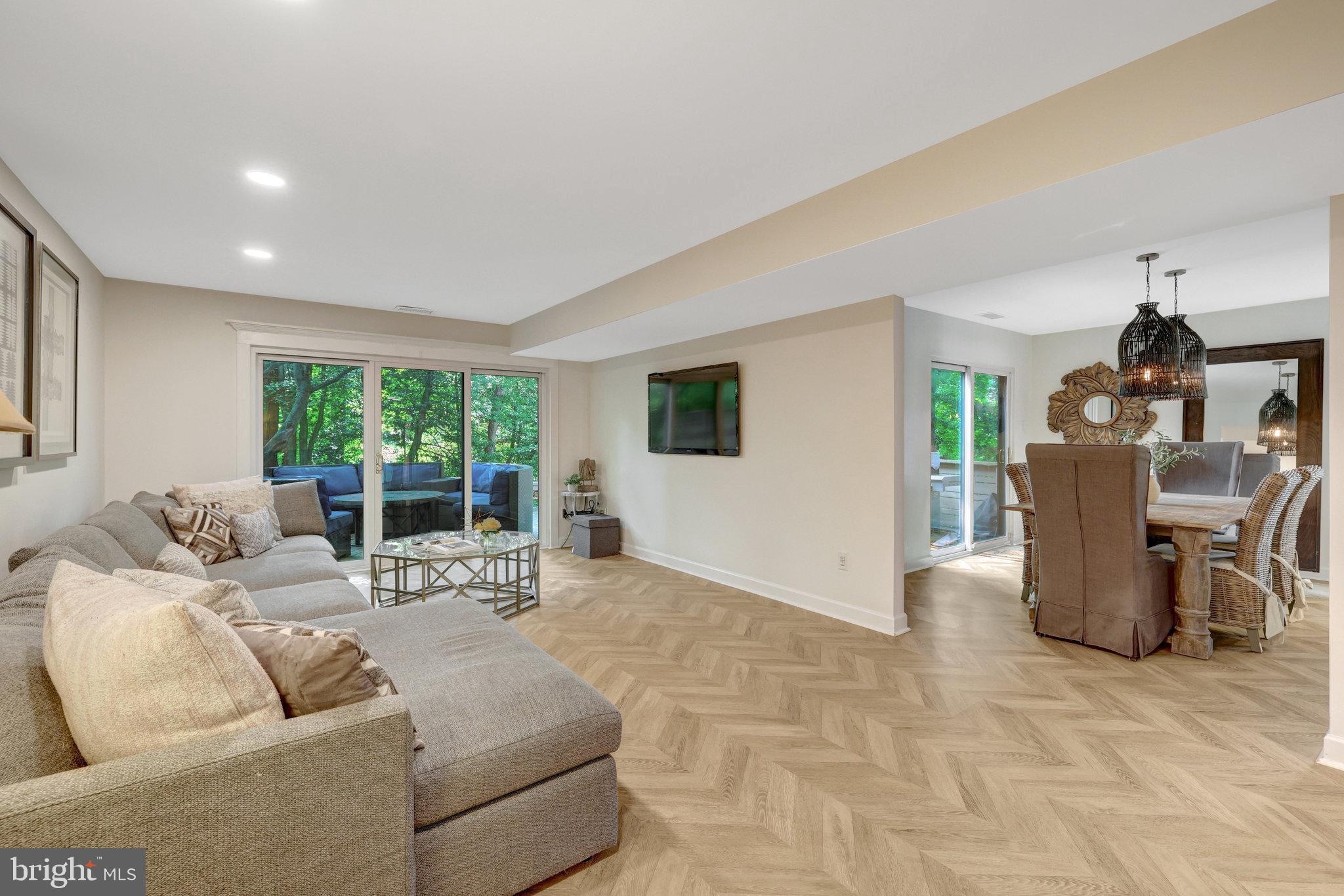 11712 Indian Ridge Road Reston, VA 20191 - Photo 32 of 77 a living room with furniture a window and a dining table