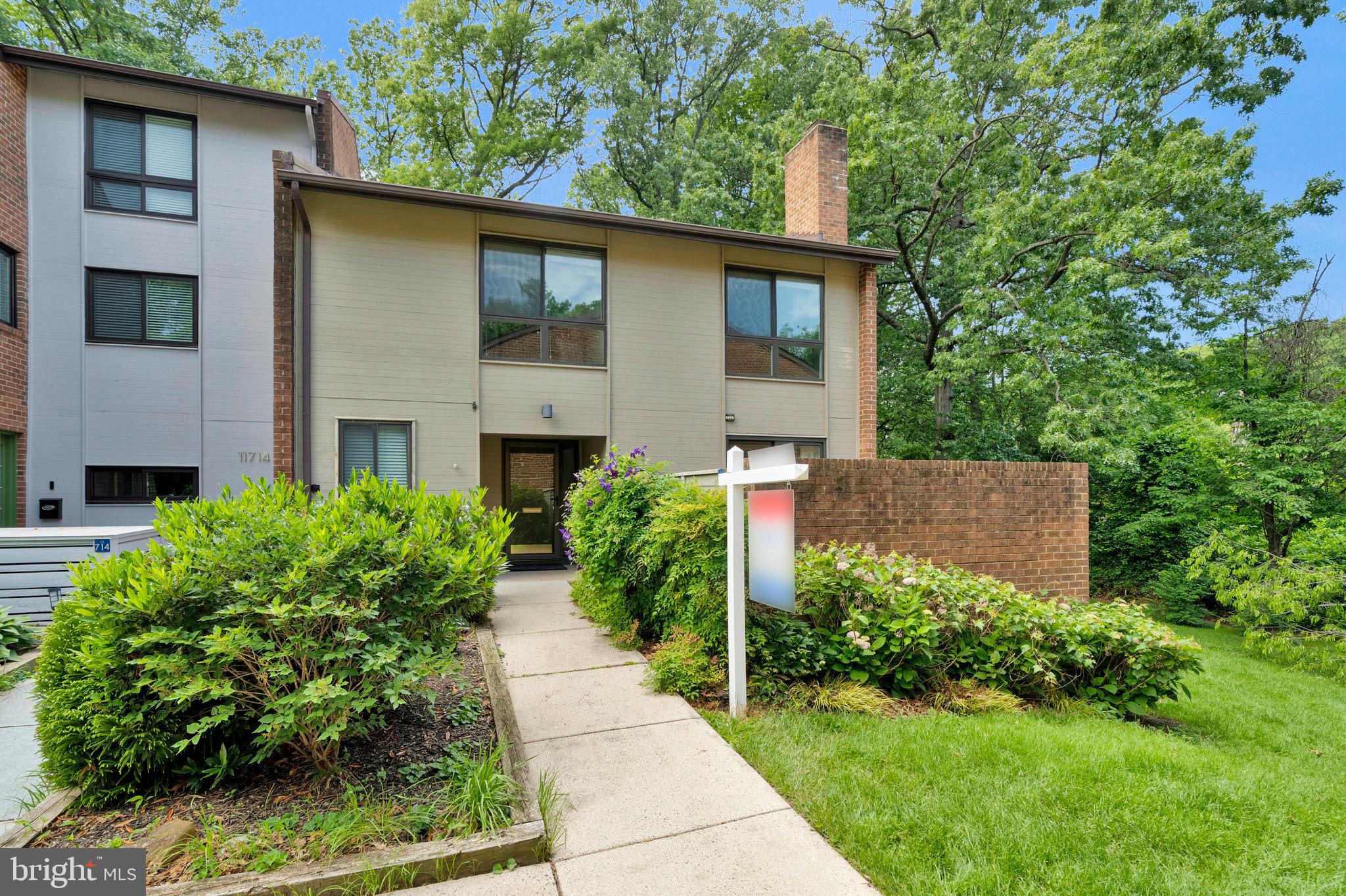 11712 Indian Ridge Road Reston, VA 20191 - Photo 5 of 77 a front view of a house with garden