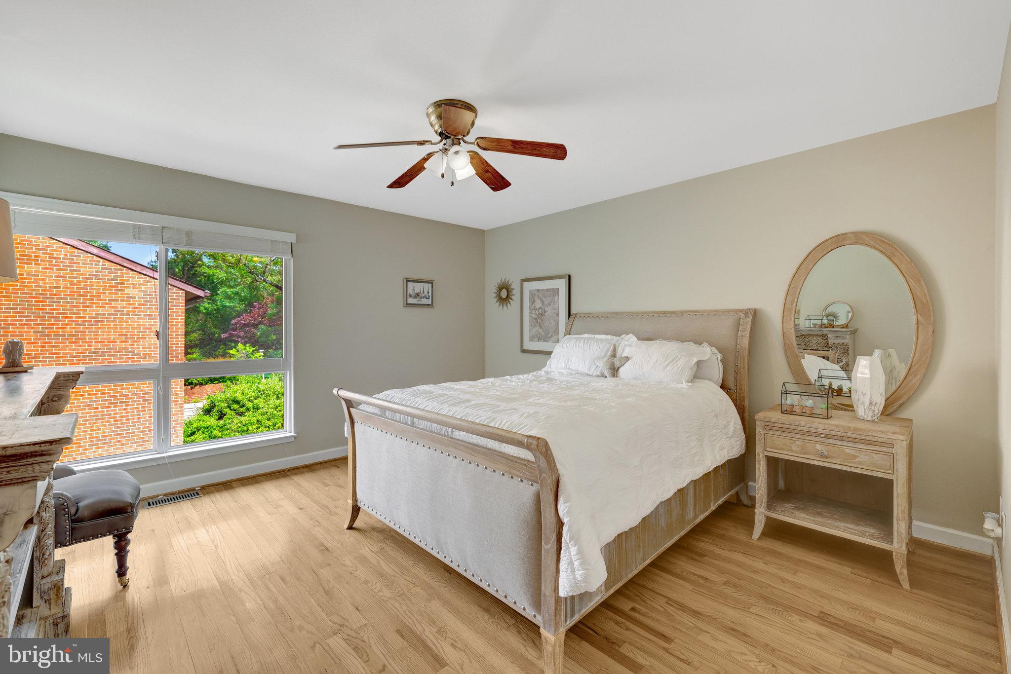 11712 Indian Ridge Road Reston, VA 20191 - Photo 65 of 77 a bed sitting in a bedroom next to a window