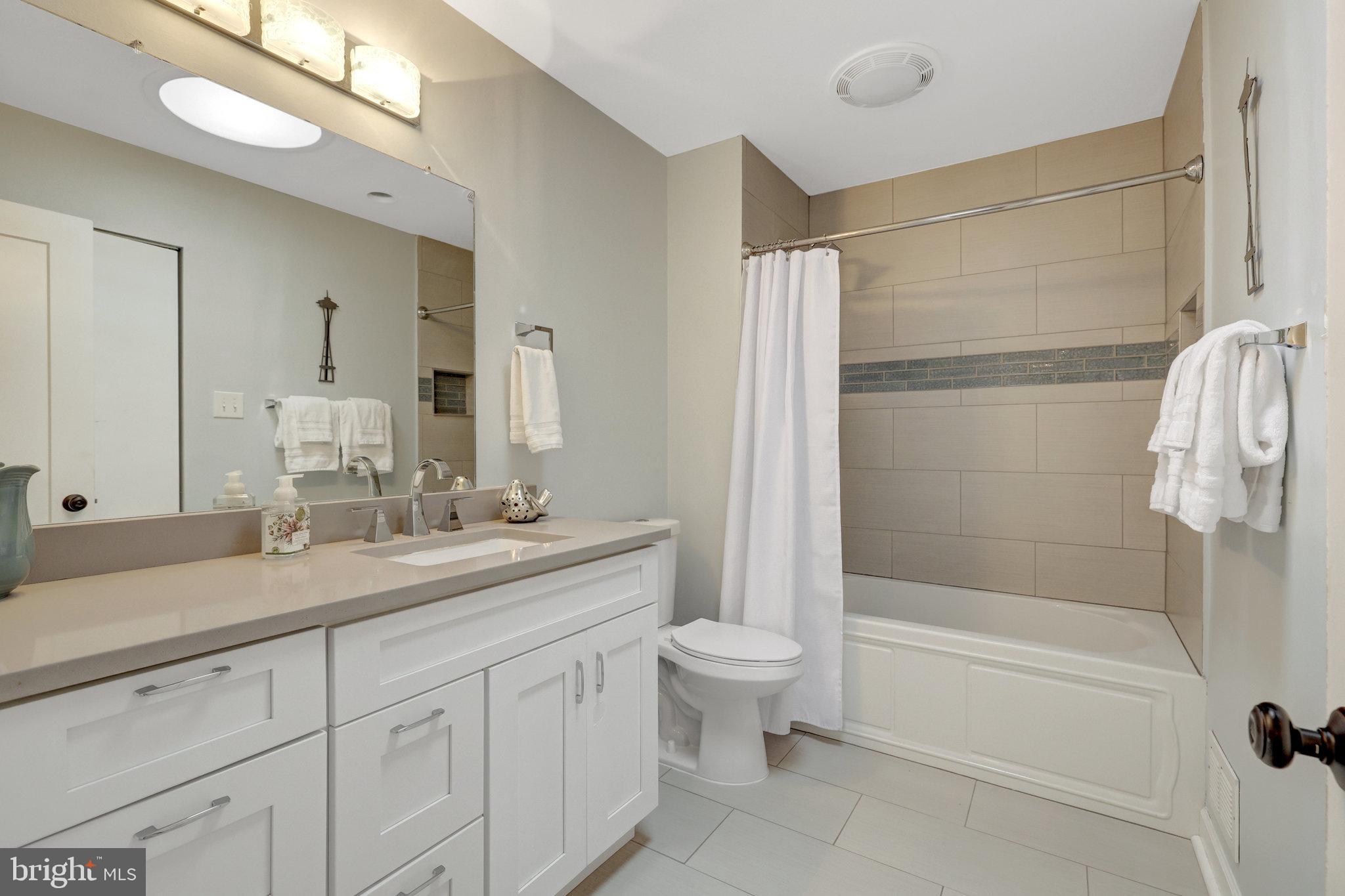 11712 Indian Ridge Road Reston, VA 20191 - Photo 73 of 77 a bathroom with a granite countertop sink a toilet and shower