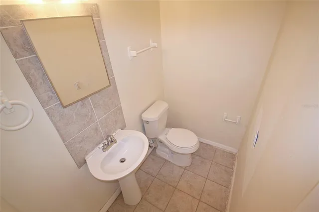 a bathroom with a toilet a sink and a mirror