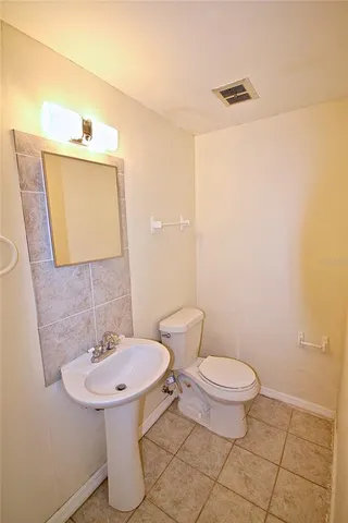 a bathroom with a sink toilet and mirror