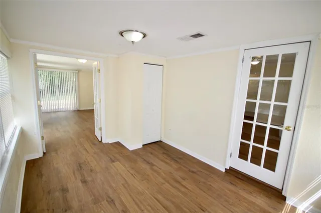 wooden floor in an empty room with a window