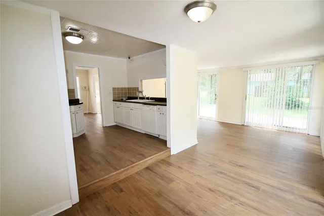 a view of a kitchen with a stove wooden cabinets and a refrigerator
