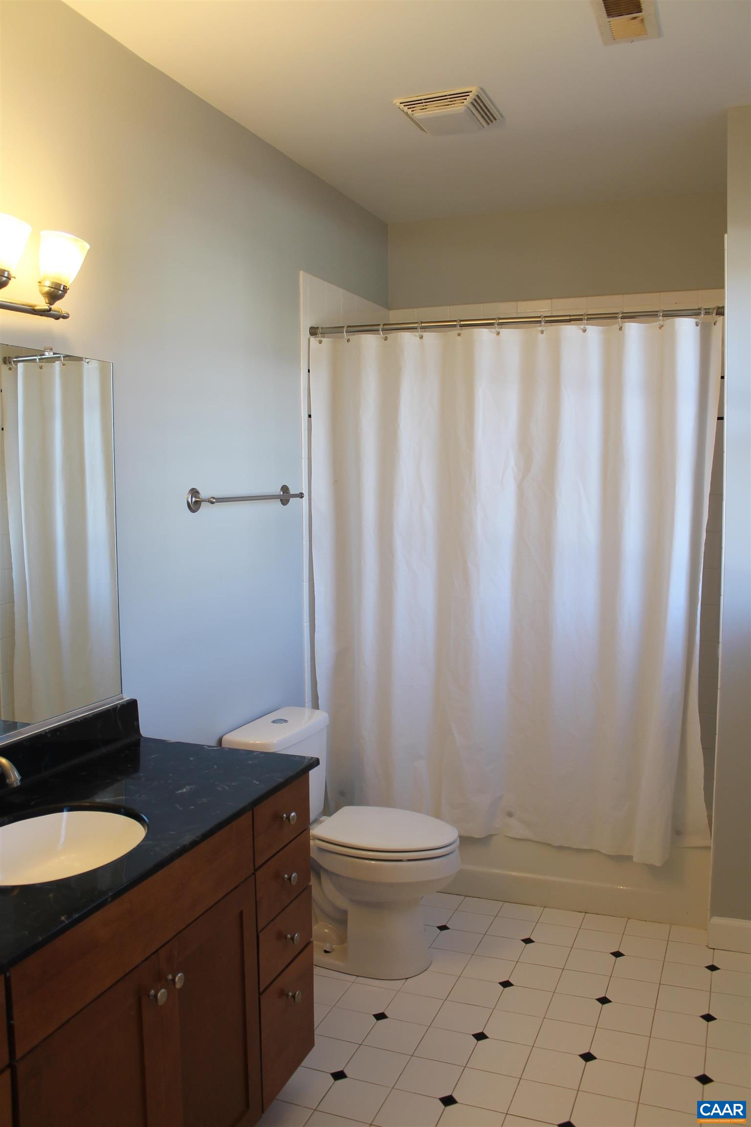211 Spruce Street Charlottesville, VA 22902 - Photo 18 of 58 a bathroom with a granite countertop sink toilet and shower