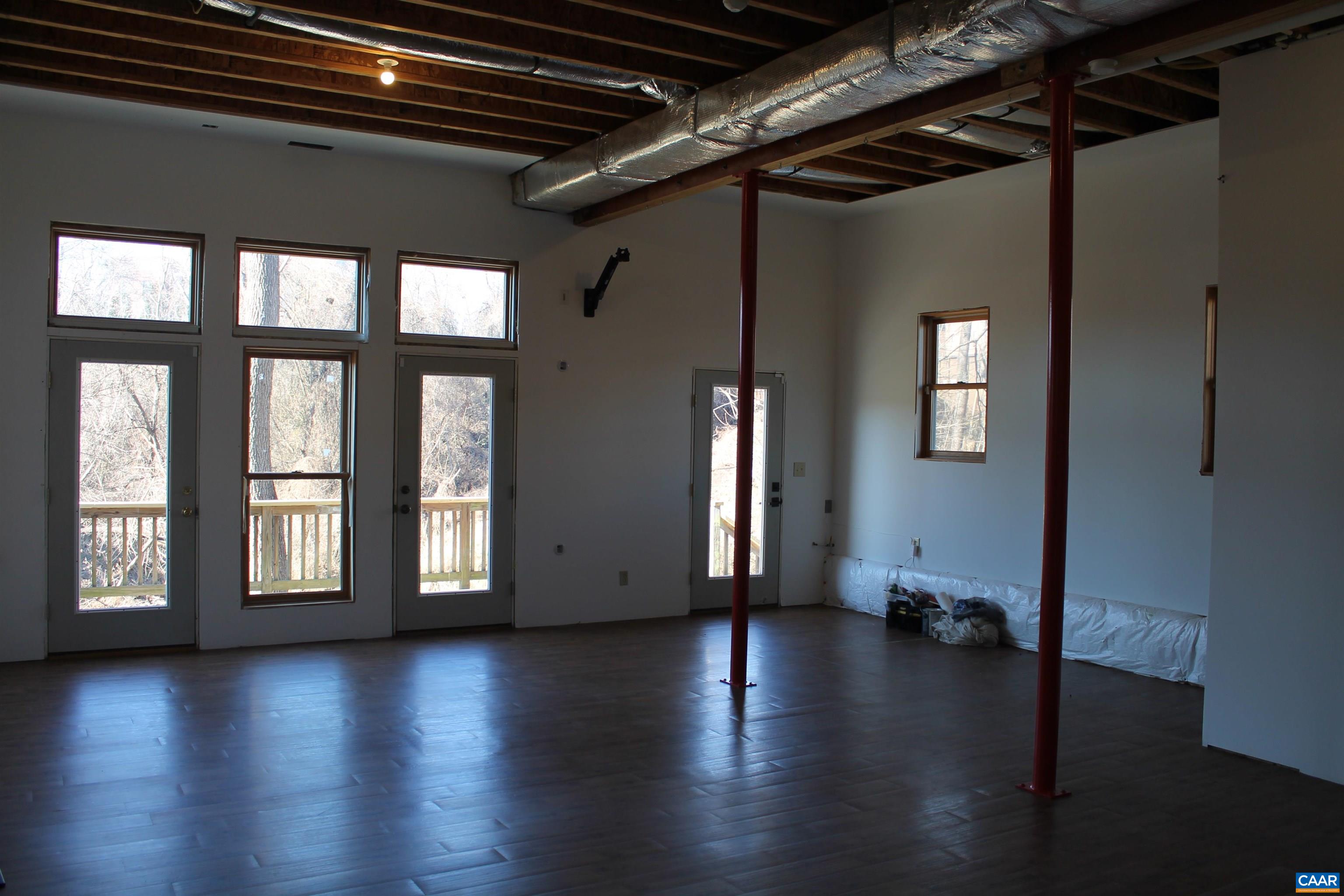 211 Spruce Street Charlottesville, VA 22902 - Photo 52 of 58 a view of an empty room with wooden floor and a window