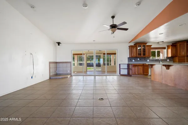 a view of a yard with wooden fence