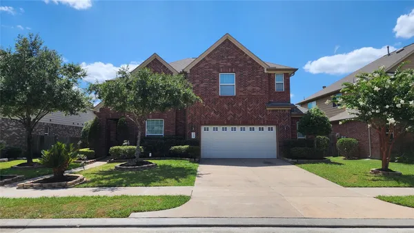 a front view of a house with yard and garage