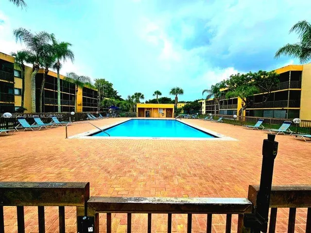 a view of swimming pool with an outdoor seating