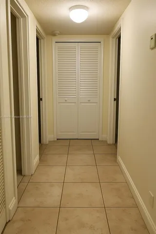 a view of a livingroom with an empty space and a window
