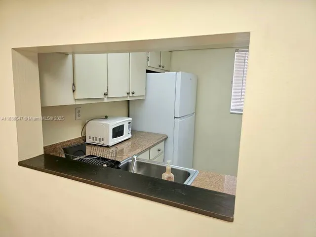 a kitchen with a refrigerator and a stove