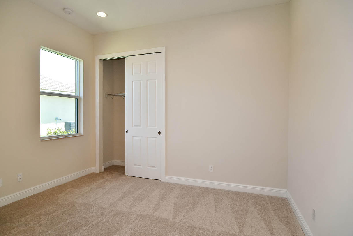 7414 Southeast Ravissant Drive Stuart, FL 34997 - Photo 12 of 25 an empty room with windows and closet