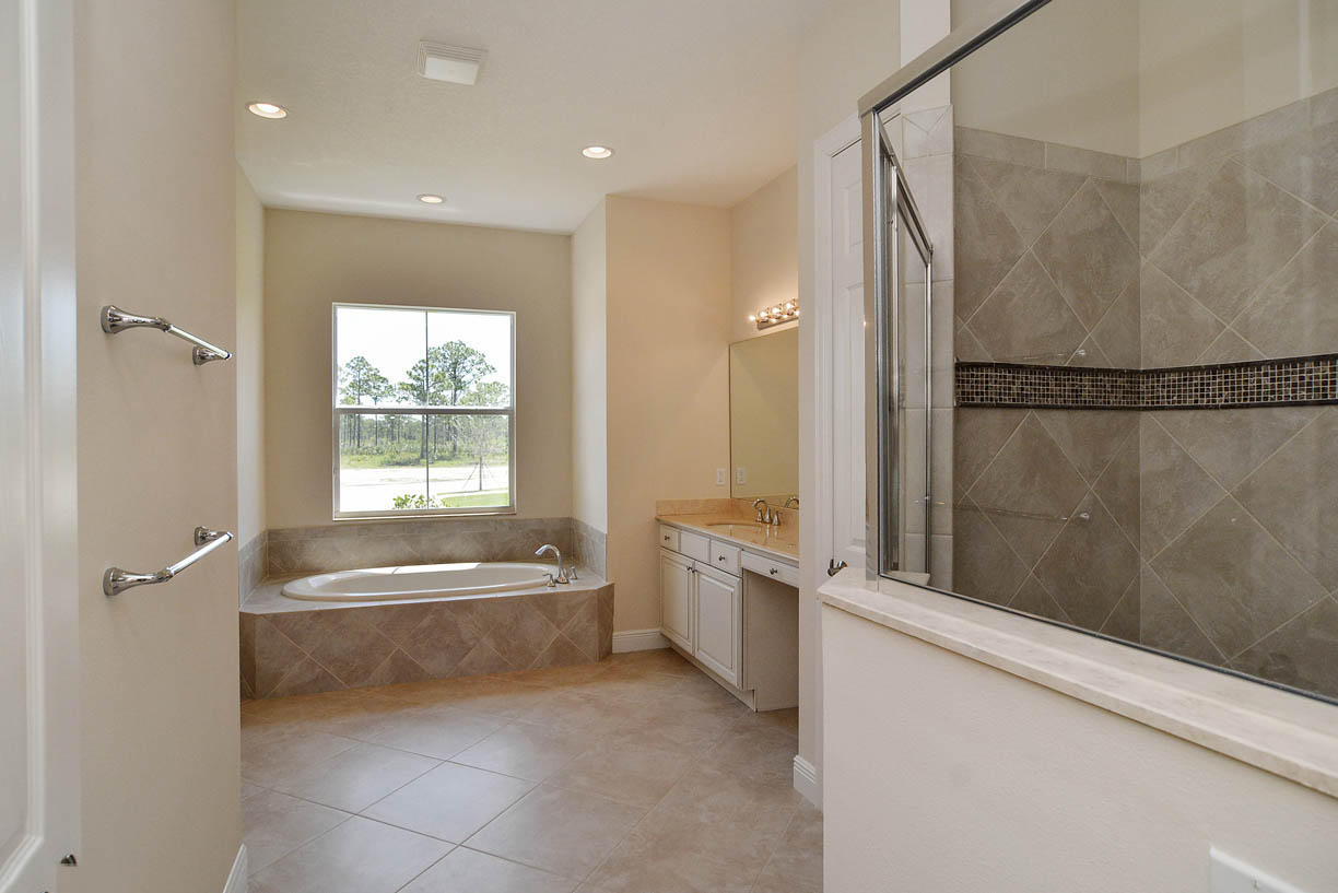 7414 Southeast Ravissant Drive Stuart, FL 34997 - Photo 7 of 25 a spacious bathroom with a bathtub and a shower
