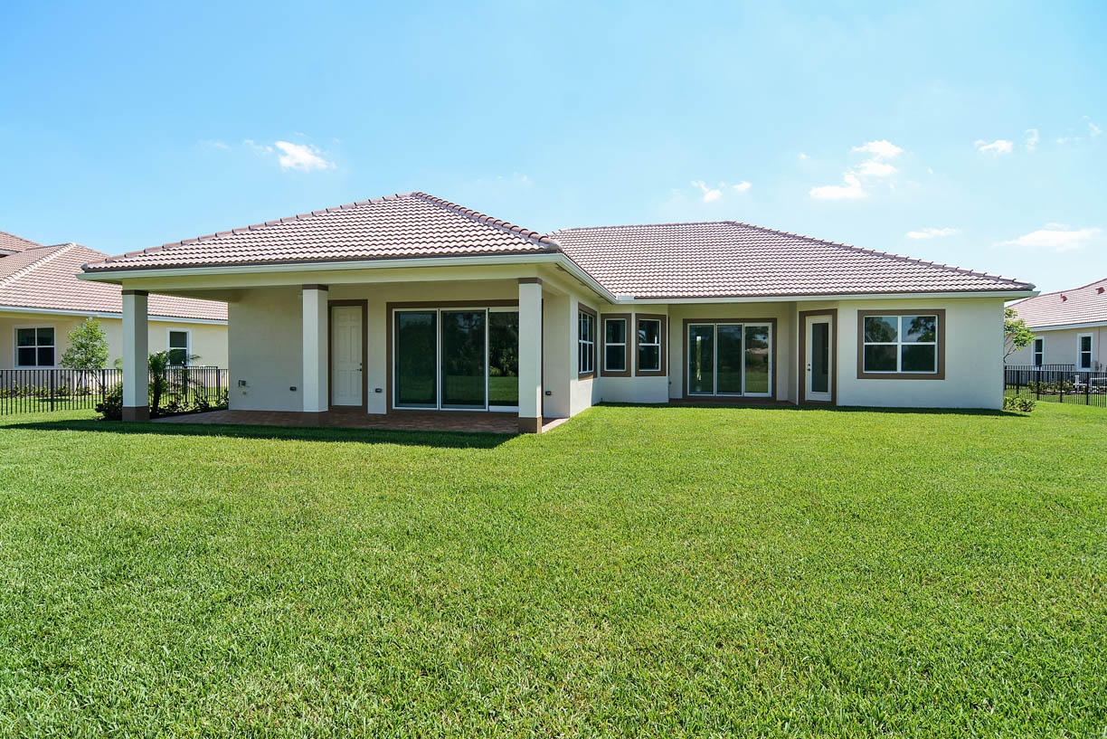 7414 Southeast Ravissant Drive Stuart, FL 34997 - Photo 8 of 25 a view of a house with a yard and plants