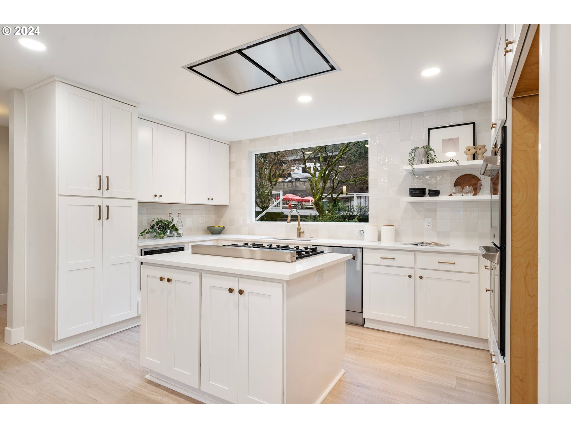 2711 Greentree Road Lake Oswego, OR 97034 - Photo 11 of 42 a kitchen with kitchen island a sink appliances and cabinets