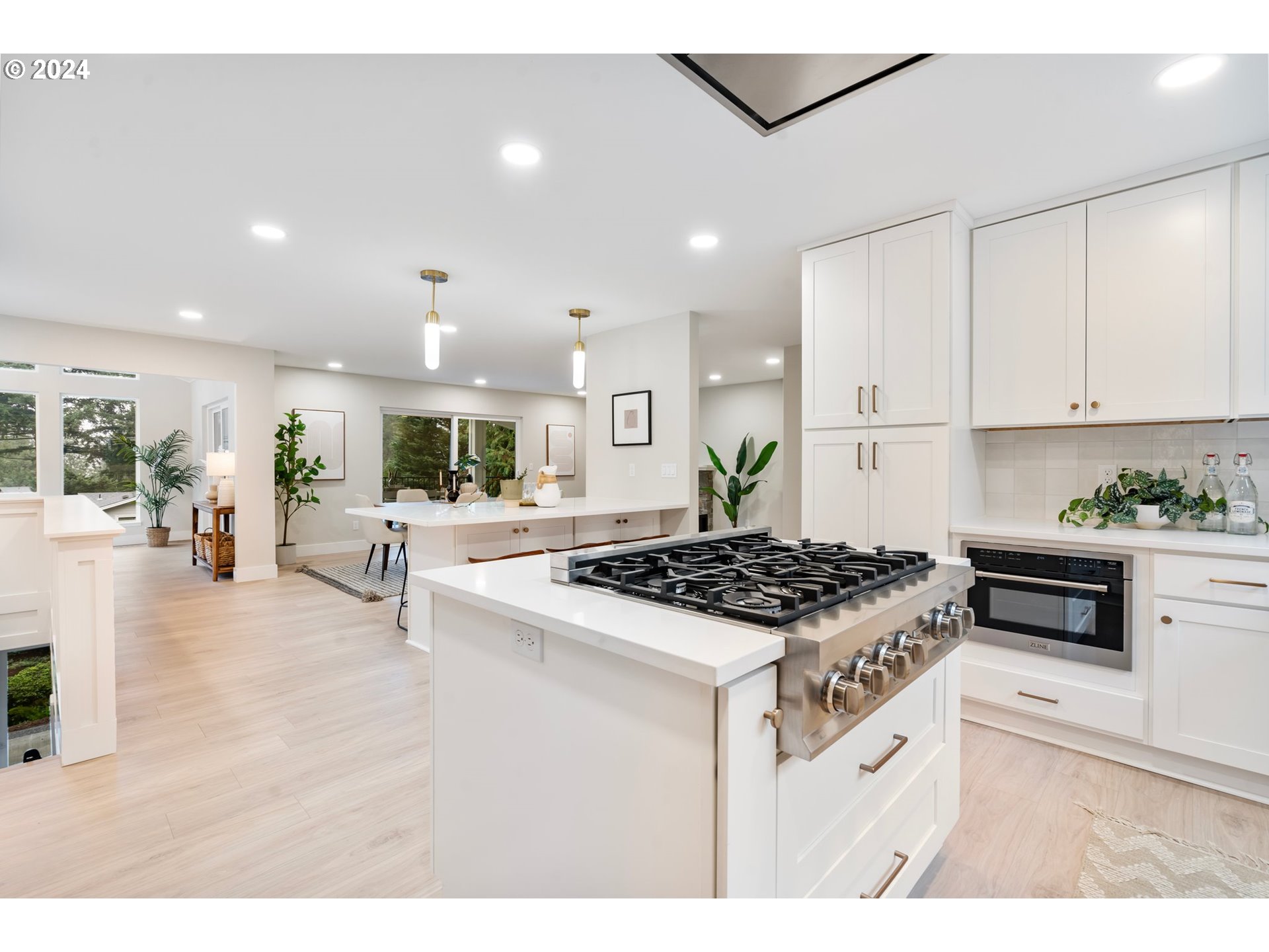 2711 Greentree Road Lake Oswego, OR 97034 - Photo 10 of 42 a kitchen with stainless steel appliances granite countertop a stove a sink a refrigerator and white cabinets