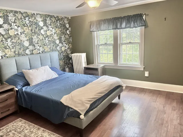 a bedroom with a bed and window