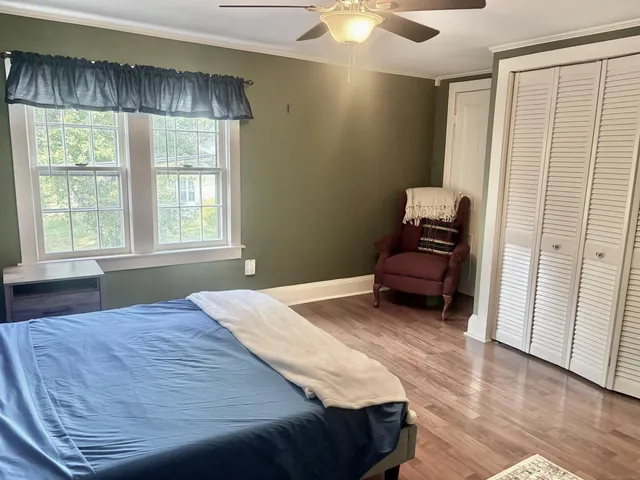 a bedroom with a bed and a window