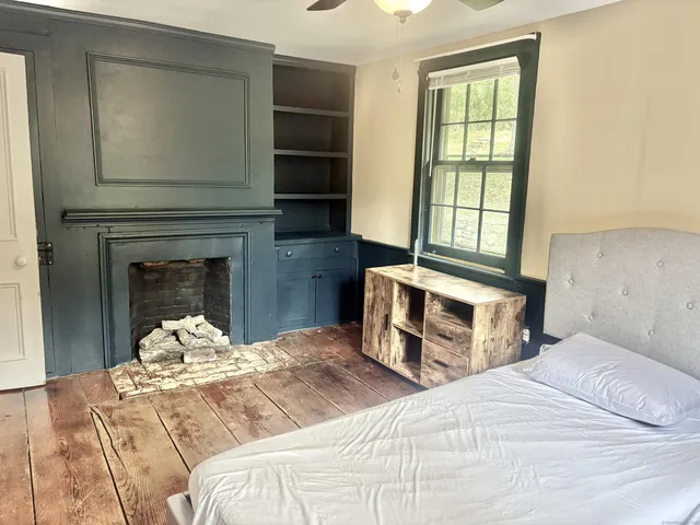 a bedroom with a bed and a window