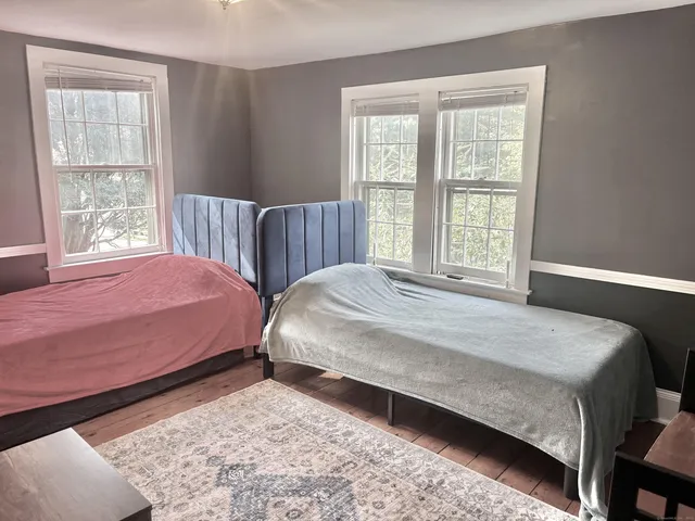 a bedroom with two beds and a window