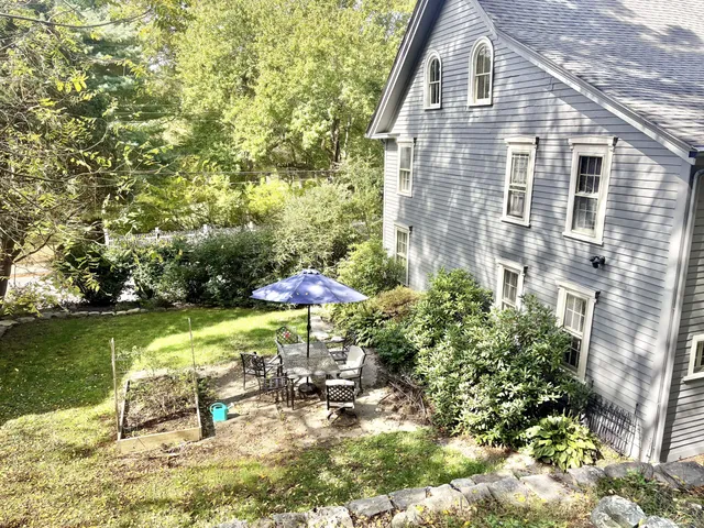 a view of a house with backyard porch and sitting area
