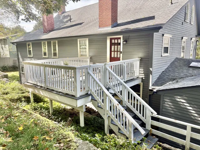a view of a house with wooden deck