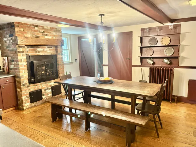 a living room with furniture a table and a fireplace