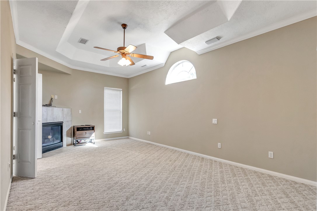 1602 Leopard Court College Station, TX 77840 - Photo 16 of 28 an empty room with fireplace and windows