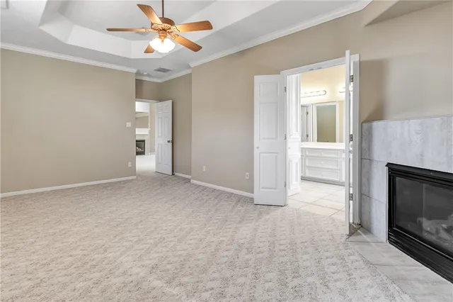 a view of empty room with fireplace and fan